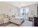 Bright bedroom featuring a chandelier, large window with sheer curtains, and neutral decor at 13348 Panama Beach Ct, Orlando, FL 32827