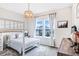 Cozy bedroom with a bunk bed, large windows, and a decorative pendant light fixture at 13348 Panama Beach Ct, Orlando, FL 32827