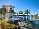 A stone community entrance featuring a waterfall, sign and decorative palm trees at 13348 Panama Beach Ct, Orlando, FL 32827