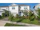Charming two-story home showcasing a manicured lawn and lovely landscaping at 13348 Panama Beach Ct, Orlando, FL 32827
