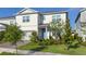 Charming two-story home showcasing a manicured lawn and lovely landscaping at 13348 Panama Beach Ct, Orlando, FL 32827