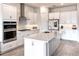 Modern kitchen with stainless appliances, white cabinets, and large island at 13348 Panama Beach Ct, Orlando, FL 32827