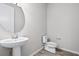 Powder room featuring a pedestal sink and toilet at 13348 Panama Beach Ct, Orlando, FL 32827