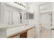 Bathroom featuring neutral tile flooring, a large mirror and a white vanity at 15 Silver Park Cir, Kissimmee, FL 34743