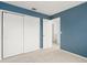 Bedroom with closet and light blue wall paint, and tiled floor at 15 Silver Park Cir, Kissimmee, FL 34743