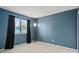 Bedroom featuring blue walls, a window with blinds and curtains, and tiled floors at 15 Silver Park Cir, Kissimmee, FL 34743