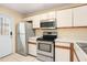 Functional kitchen featuring stainless steel appliances and ample counter space at 15 Silver Park Cir, Kissimmee, FL 34743