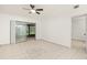 Bright living room featuring neutral tile flooring, white walls and views to the screened patio at 15 Silver Park Cir, Kissimmee, FL 34743