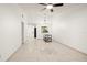 Bright living room featuring neutral tile flooring, white walls and modern lighting fixture at 15 Silver Park Cir, Kissimmee, FL 34743