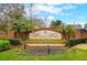 Welcoming community entrance sign amidst lush greenery at 15848 Autumn Glen Ave, Clermont, FL 34714