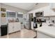 Bright kitchen featuring white cabinets, stainless steel appliances, and tile flooring at 15848 Autumn Glen Ave, Clermont, FL 34714