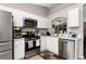 Well-lit kitchen featuring stainless steel appliances and white cabinets at 15848 Autumn Glen Ave, Clermont, FL 34714