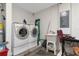 Bright laundry room with washer, dryer, and utility sink at 15848 Autumn Glen Ave, Clermont, FL 34714