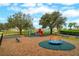 Community playground with mature trees, safety ground cover and secure fencing provides hours of enjoyment at 15848 Autumn Glen Ave, Clermont, FL 34714