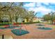 Community playground with swings, slides, and other play equipment provides fun for children of all ages at 15848 Autumn Glen Ave, Clermont, FL 34714