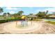 Community splash pad and pool surrounded by lounge chairs and umbrellas provide fun for all ages at 15848 Autumn Glen Ave, Clermont, FL 34714