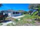 View of a flat backyard features a covered patio on the back of this cozy, single story home at 161 Randia Dr, Orlando, FL 32807