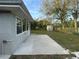 Home's backyard featuring a newly installed patio and green lawn at 161 Randia Dr, Orlando, FL 32807