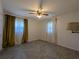 Cozy bedroom with neutral walls, tiled floor, a ceiling fan, and bright windows at 161 Randia Dr, Orlando, FL 32807