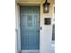 Charming blue front door with decorative details, mailbox, and lantern, creating a welcoming entrance at 161 Randia Dr, Orlando, FL 32807