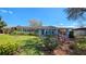 Single-story home with tidy landscaping, blue shutters, and an attached carport on a sunny day at 161 Randia Dr, Orlando, FL 32807