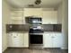 Efficient kitchen with stainless steel appliances, white cabinetry, and a neutral backsplash for a modern touch at 161 Randia Dr, Orlando, FL 32807