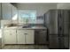 Well-lit kitchen featuring a stainless steel refrigerator and modern dishwasher adding to a functional design at 161 Randia Dr, Orlando, FL 32807