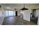 Open-concept living room with tile flooring, a ceiling fan, and plenty of natural light at 161 Randia Dr, Orlando, FL 32807