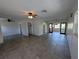 Spacious living room featuring tile flooring, ceiling fan, and access to the sunroom at 161 Randia Dr, Orlando, FL 32807