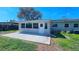 Back patio leads to the enclosed sunroom with a large yard, offering an inviting outdoor space at 161 Randia Dr, Orlando, FL 32807