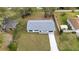 Aerial view of a well-maintained home showcasing its new roof, landscaping, and extended driveway at 1625 Victory Palm Dr, Edgewater, FL 32132