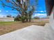 Large backyard with mature tree and concrete patio at 1625 Victory Palm Dr, Edgewater, FL 32132