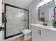 Modern bathroom with a glass-enclosed shower, stylish vanity, and marble tile walls at 1625 Victory Palm Dr, Edgewater, FL 32132