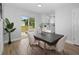 Bright dining room featuring a modern table with comfortable chairs, and a sliding door to the backyard at 1625 Victory Palm Dr, Edgewater, FL 32132