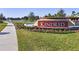 A beautiful community entrance with a water feature, landscaping, and the 'Kindred' sign at 1642 Badger Creek Rd, Kissimmee, FL 34744