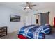 Comfortable bedroom showcasing a bed with a colorful quilt, ceiling fan and a barn-style door to the bathroom at 168 Victoria Oaks Blvd, Deland, FL 32724