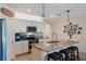 Well-lit kitchen with stainless steel appliances, a granite island with seating, and decor elements at 168 Victoria Oaks Blvd, Deland, FL 32724