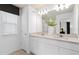 Elegant bathroom featuring a double vanity with quartz countertop and modern fixtures, plus a window at 1713 Delightful Dr, Davenport, FL 33896