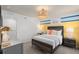 Bedroom featuring bright yellow and blue accent wall, a bed, and stylish lighting at 1713 Delightful Dr, Davenport, FL 33896