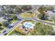 Aerial view of the community with pool, playground, and manicured roundabout at 17343 Summer Oak Ln, Clermont, FL 34711