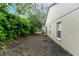 Side yard of home showcasing sparse landscaping and a neutral exterior at 17343 Summer Oak Ln, Clermont, FL 34711