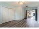 Bedroom featuring wood floors, closet, and a sliding glass door leading to the outside at 17343 Summer Oak Ln, Clermont, FL 34711