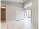 Bright bedroom with tile flooring, natural light and sliding glass door to patio at 17343 Summer Oak Ln, Clermont, FL 34711