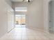 Bright bedroom featuring tile flooring, neutral paint, and large sliding doors at 17343 Summer Oak Ln, Clermont, FL 34711