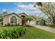 Well-manicured front yard and neutral home exterior with palms at 17343 Summer Oak Ln, Clermont, FL 34711