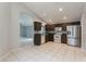 Spacious kitchen with tile flooring, stainless steel refrigerator and white appliances at 17343 Summer Oak Ln, Clermont, FL 34711