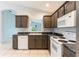 Corner view of bright kitchen with a corner sink, and white appliances at 17343 Summer Oak Ln, Clermont, FL 34711