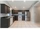 Spacious kitchen with tile flooring, stainless steel refrigerator and white appliances at 17343 Summer Oak Ln, Clermont, FL 34711