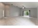 Spacious living room with tile floors, neutral walls, and sliding glass doors at 17343 Summer Oak Ln, Clermont, FL 34711