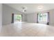 Bright living area featuring tile flooring, neutral walls, and sliding glass doors at 17343 Summer Oak Ln, Clermont, FL 34711